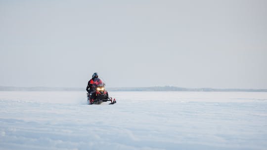 Snowmobile safari through Lappish forest